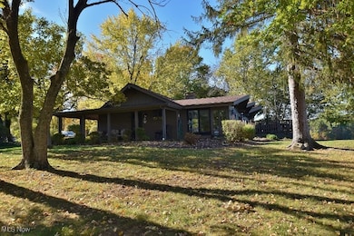 A side view of the home. A wrap around deck offers both covered and open sitting areas
