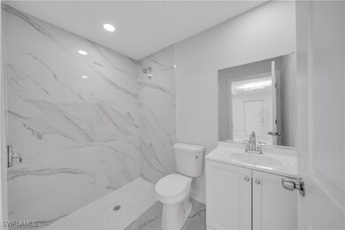 Full bathroom with marble finish floor, toilet, va