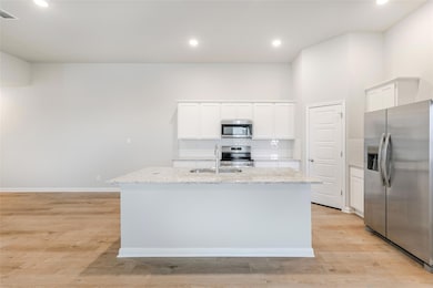 Kitchen with stainless steel appliances, a sink, 