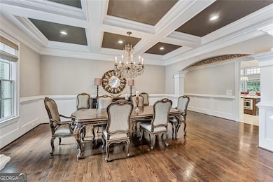 Beautifully appointed dining room with coffered ceiling and smoky crystal chandelier