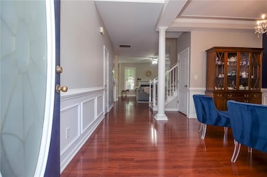 Entrance foyer featuring decorative columns, stair