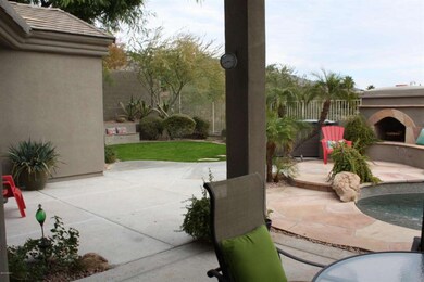 View of grassy area, fireplace & patio