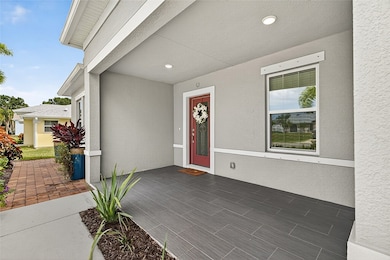 Property entrance featuring stucco siding and a porch