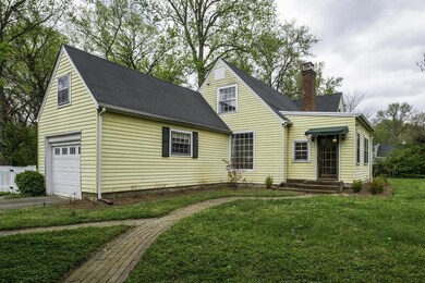 Brick pathways lead to the Entry  of the home,sheltered by a canvas awning
