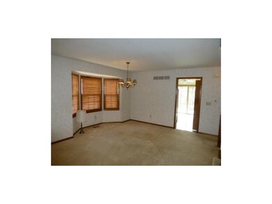 Dining area with bay window - door into kitchen