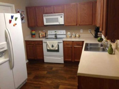 kitchen with faux hardwood flooring. low maintenance.  window overlooking large level back yard at sink