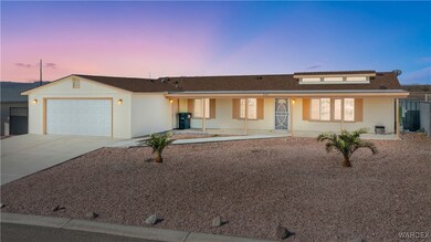 Single story home featuring a garage, fence, concr
