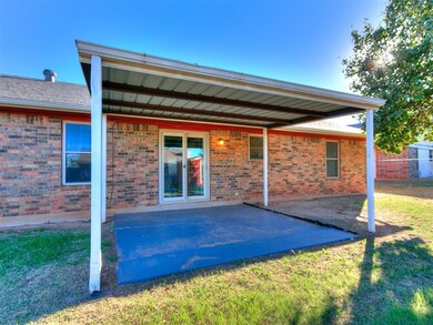 Back of property with a yard and a patio area