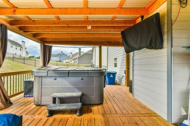 Deck with fence and a hot tub