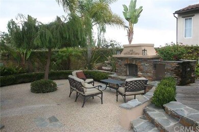 Back yard patio area with custom, stone gas firepl