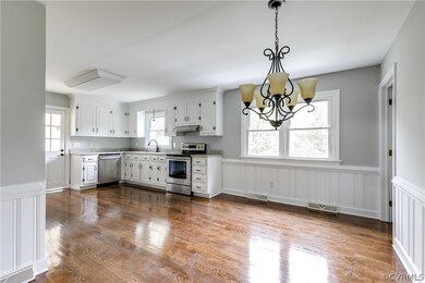The refinished hardwood floors continue into the e