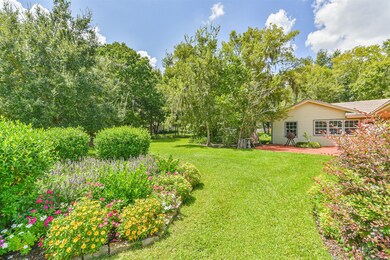 View of the lush and expansive back yard and gardens.