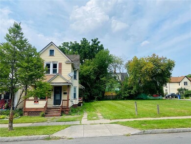 Side of home with open lot next door.