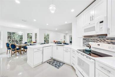 Kitchen featuring white appliances, trendy lights 