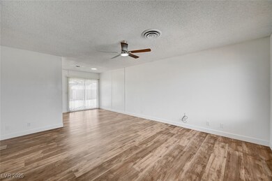 Spare room with a ceiling fan, wood finished floor