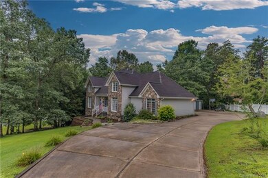 Concrete driveway leads to attached garage