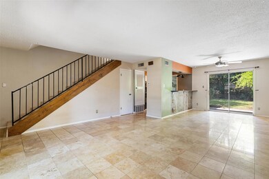 Vast living and dining room with beautiful tile flooring and easy access to backyard