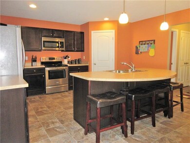 The stunning kitchen features tear drop pendant li