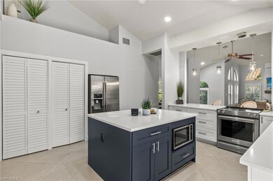 Kitchen featuring ceiling fan, appliances with sta