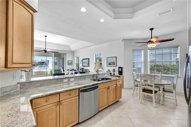 Kitchen featuring dishwasher, sink, a raised ceili