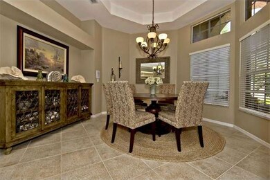 Elegant formal dining room with tray ceiling.