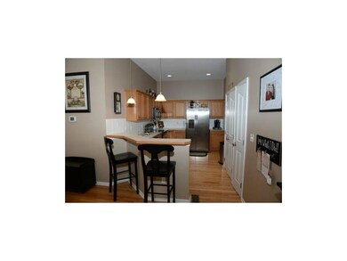 Kitchen with area for bar stools and double door p