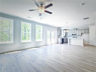 Unfurnished living room featuring visible vents, l