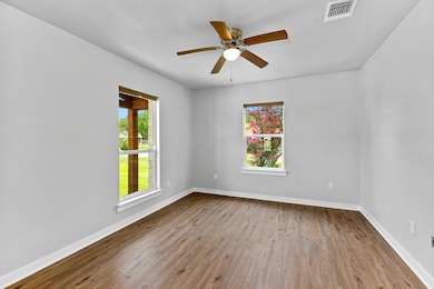 Spare room featuring baseboards, ceiling fan, and