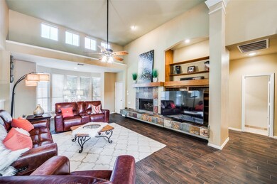 Spacious living room with a stone fireplace and bu