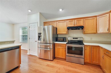 Kitchen with maple cabinetry and stainless steel a