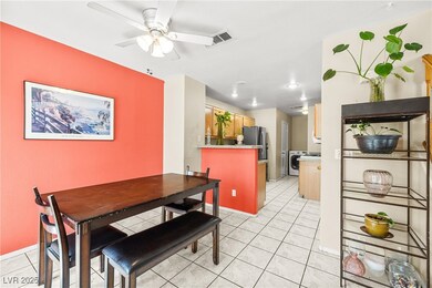 Dining room with ceiling fan and light tile patter