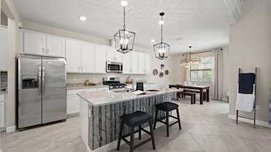 For delicious meals of all sizes, this modern kitchen features a stunning granite center island, sta