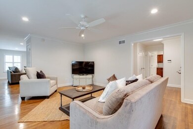 Living room with crown molding, baseboards, ceilin
