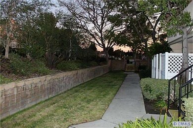 Landscape and walkway in front of unit.