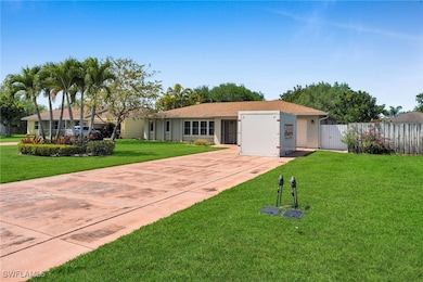 Ranch-style house with stucco siding, driveway, a