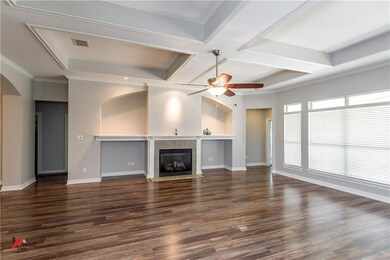 Living room features a beautiful coffered ceiling,