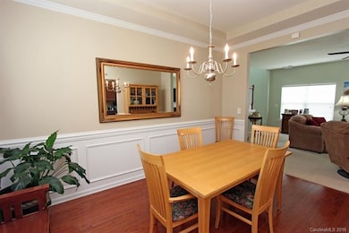 Dining Room with 2 piece chair railing , crown molding, prefinished hardwood flooring.