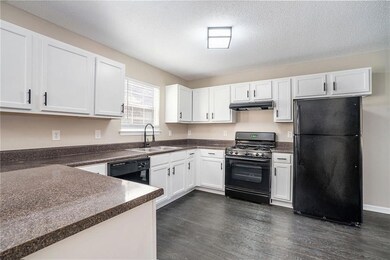 Kitchen featuring sink, dark hardwood / wood-style