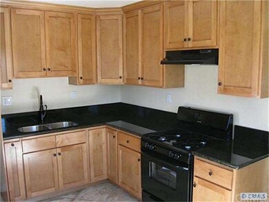Kitchen w/ custom cabinets and granite counters.