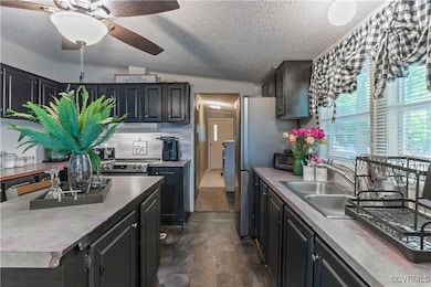 Kitchen featuring a textured ceiling, lofted ceili