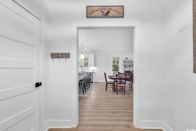 Hall with light hardwood / wood-style flooring