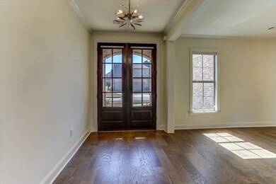 Doorway with dark wood-style floors, french doors, a healthy amount of sunlight, and baseboards