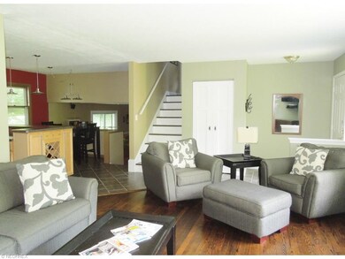 Living room with beautiful wood flooring, bright a