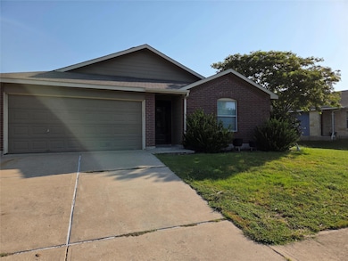 Single story home with brick siding, driveway, a front yard, a garage, and roof with shingles