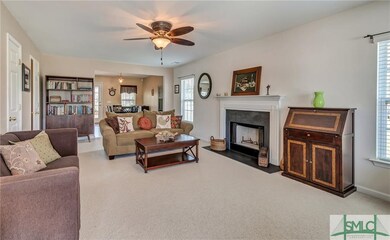 Living room has wood burning fireplace, ceiling fa