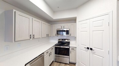 Kitchen with light wood-style floors, stainless st
