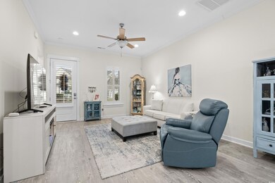Living room featuring ceiling fan, light hardwood 
