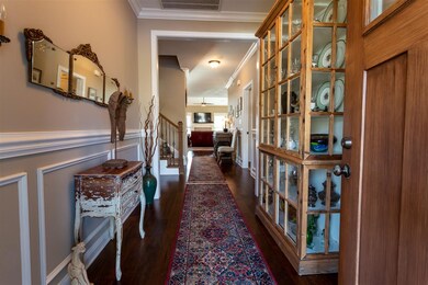 The foyer is a show piece with crown molding and w
