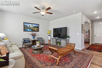 Living room featuring a ceiling fan and LVP Flooring