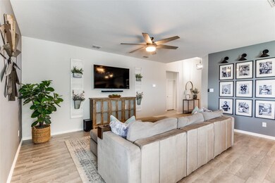 Living area with light wood-type flooring, a ceili